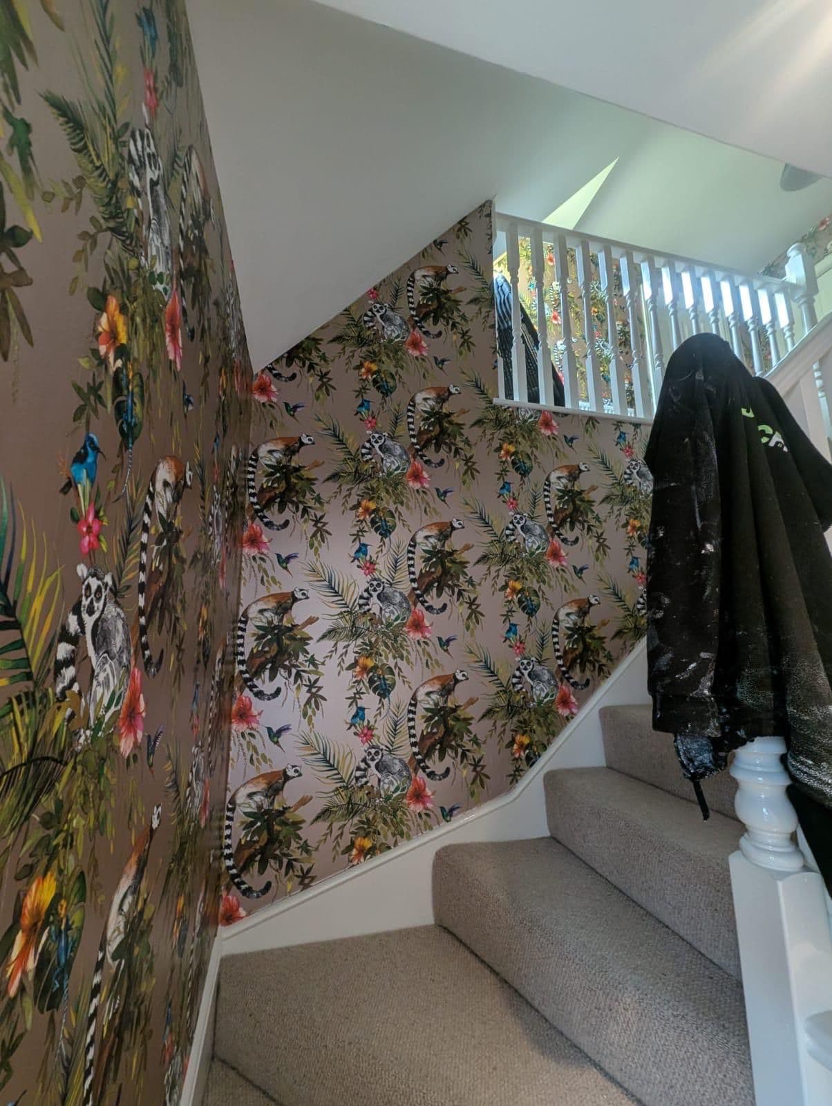 Staircase with colourful tropical animal print wallpaper