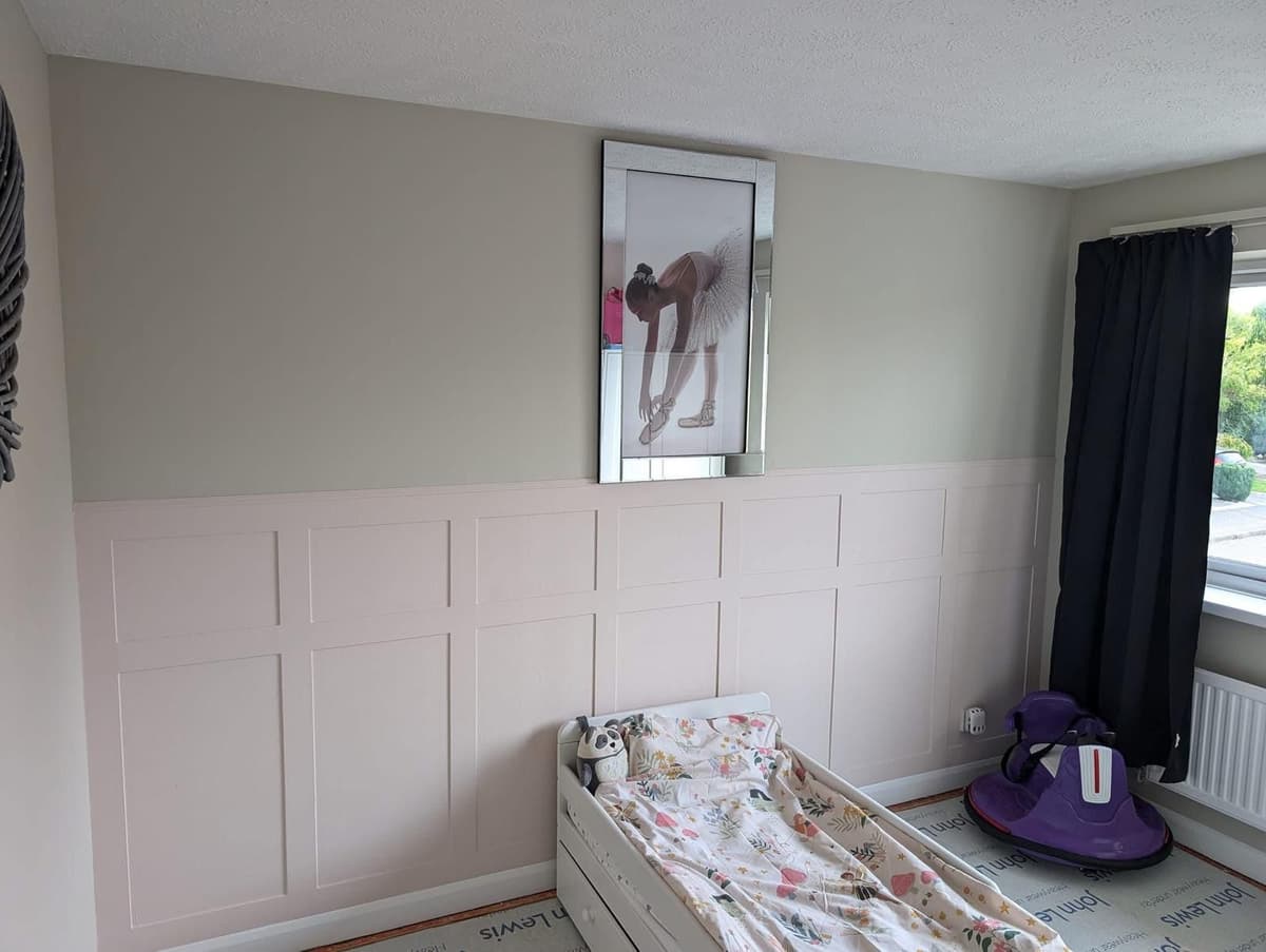 Children's bedroom with pink shaker panelling and sage walls